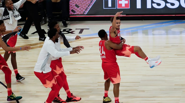 Trae Young of the Atlanta Hawks is lifted after making a three-point basket during to end the first half of the NBA All-Star basketball game Sunday, Feb. 16, 2020, in Chicago.