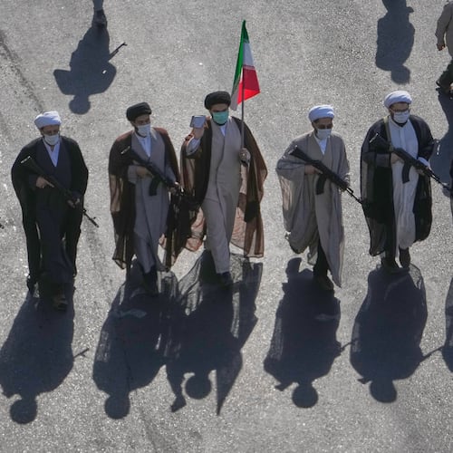Shiite clerics carrying rifles march during the state-organized "Janfada," or "Sacrifice for Iran," military-style parade at Revolution Square in Tehran, Iran, Friday, Sept. 18, 2026. (AP Photo/Vahid Salemi)