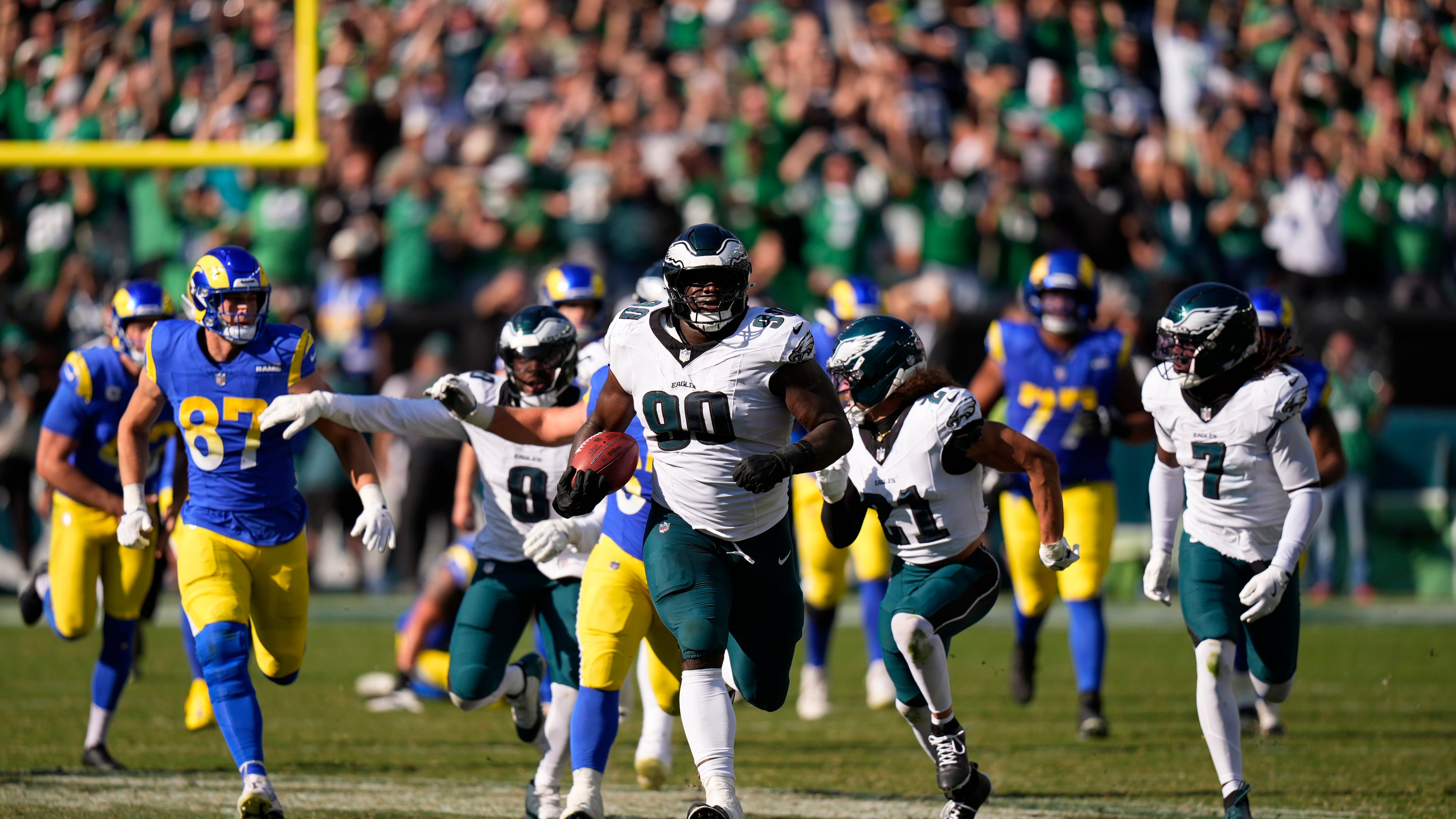 Philadelphia Eagles defensive tackle Jordan Davis (90) runs the ball back for a touchdown after blocking a field goal attempt as time expires during the second half of an NFL football game against the Los Angeles Rams Sunday, Sept. 21, 2025, in Philadelphia. (AP Photo/Chris Szagola)