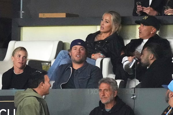Los Angeles Rams quarterback Matthew Stafford, center, watches during the second half of an MLS soccer match between Los Angeles FC and Inter Miami Wednesday, April 2, 2025, in Los Angeles. (AP Photo/Mark J. Terrill)