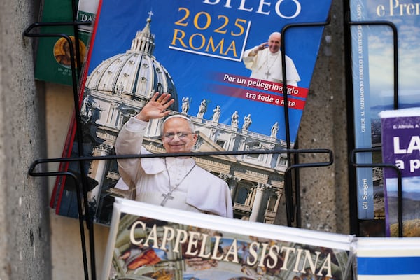A guide book with an image of Pope Leo XIV on its cover is on display outside a souvenir shop in the town of Castel Gandolfo, a historic summer retreat for popes about 30 kilometers southeast of Rome, where Pope Leo XIV will be spending a short period of rest, is seen Wednesday, July 2, 2025. (AP Photo/Andrew Medichini)