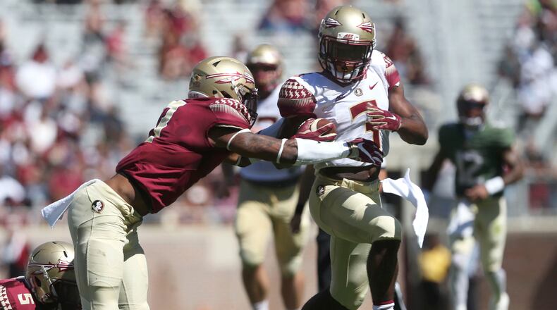 Florida State’s Cam Akers tries to break away from Stanford Samuels III during the NCAA college football team’s Garnet and Gold spring game in Tallahassee, Fla., Saturday, April 8, 2017. (Joe Rondone/Tallahassee Democrat via AP)