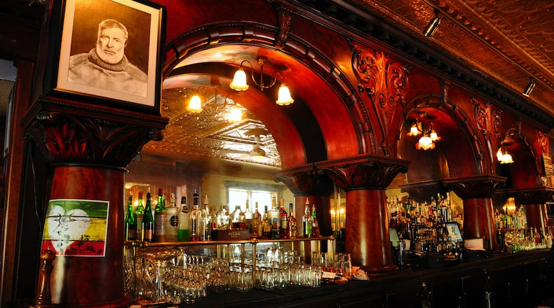 A portrait of Ernest Hemingway looks down from the mahogany bar at City Park Grill in Petoskey, Mich. (Katherine Rodeghier/Chicago Tribune/TNS)