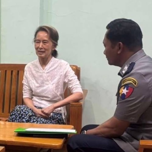 In this updated photo provided on April 30, 2026, by Myanmar Military True News Information Team, Myanmar's former leader Aung San Suu Kyi, center, talks with officials, in undisclosed location in Myanmar. (Myanmar Military True News Information Team via AP)