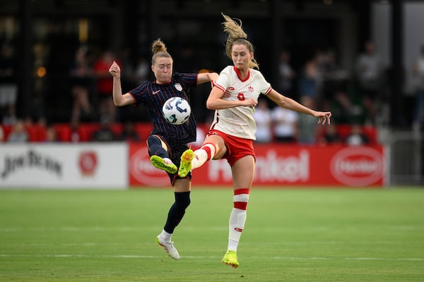 United States defender Emily Sonnett, left, and Canada forward Jordyn Huitema (9) battle for the ball during the first half of an international friendly soccer match, Wednesday, July 2, 2025, in Washington. (AP Photo/Nick Wass)
