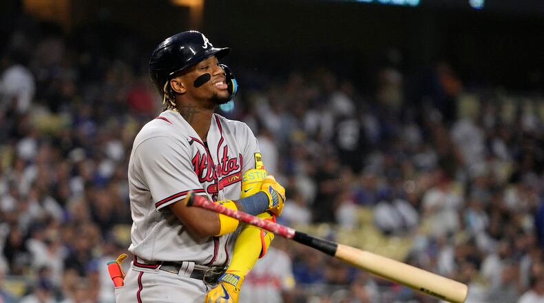 Ronald Acuna Jr. of the Braves tosses his bat after walking during the first inning of a baseball game against the Los Angeles Dodgers Friday, Sept. 1, 2023, in Los Angeles. (AP Photo/Mark J. Terrill)