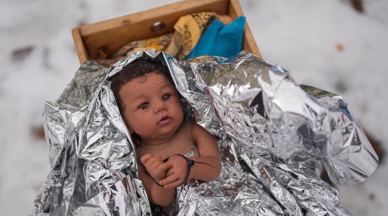 A doll representing the baby Jesus is zip-tied in the Nativity scene outside of Lake Street Church of Evanston, Wednesday, Dec. 10, 2025, in Evanston, Ill. (AP Photo/Erin Hooley)