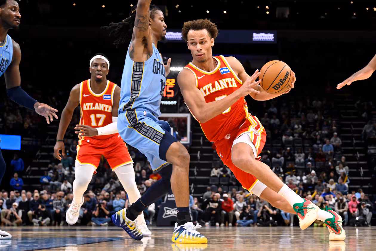 Atlanta Hawks guard Dyson Daniels (5) drives against Memphis Grizzlies guard Ja Morant (12) in the first half of an NBA basketball game Wednesday, Jan. 21, 2026, in Memphis, Tenn. (AP Photo/Brandon Dill)