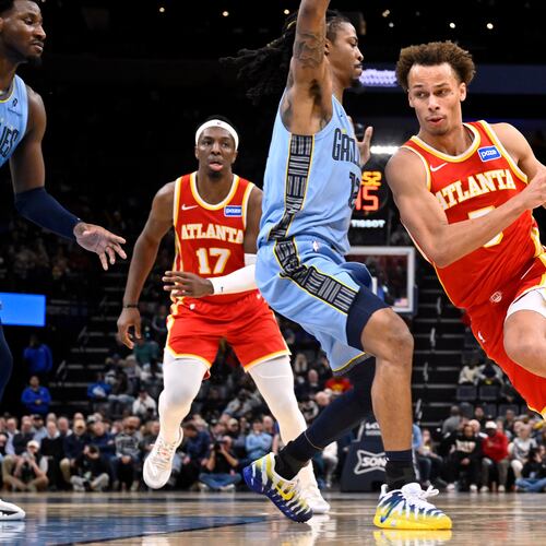 Atlanta Hawks guard Dyson Daniels (5) drives against Memphis Grizzlies guard Ja Morant (12) in the first half of an NBA basketball game Wednesday, Jan. 21, 2026, in Memphis, Tenn. (AP Photo/Brandon Dill)
