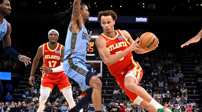 Atlanta Hawks guard Dyson Daniels (5) drives against Memphis Grizzlies guard Ja Morant (12) in the first half of an NBA basketball game Wednesday, Jan. 21, 2026, in Memphis, Tenn. (AP Photo/Brandon Dill)