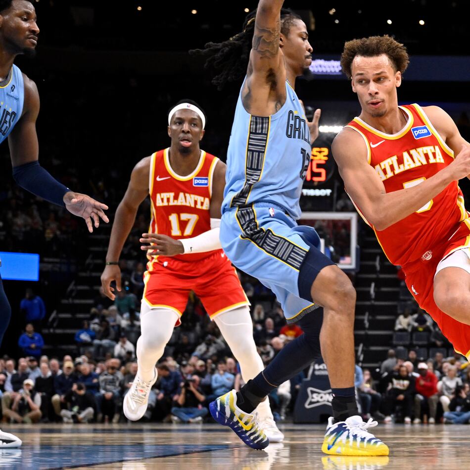 Atlanta Hawks guard Dyson Daniels (5) drives against Memphis Grizzlies guard Ja Morant (12) in the first half of an NBA basketball game Wednesday, Jan. 21, 2026, in Memphis, Tenn. (AP Photo/Brandon Dill)