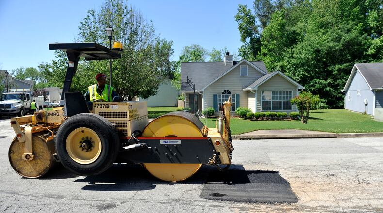 Russell James with a DeKalb County Roads and Drainage crew repairs a pothole on Springside Crossing off Columbia Drive on May 5, 2010. Bita Honarvar, bhonarvar@ajc.com