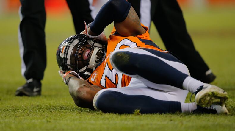 DENVER, CO - DECEMBER 28: Strong safety David Bruton #30 of the Denver Broncos lies on the ground in pain after a play that would force him out of the game with a reported concussion during a game against the Oakland Raiders at Sports Authority Field at Mile High on December 28, 2014 in Denver, Colorado. (Photo by Doug Pensinger/Getty Images)