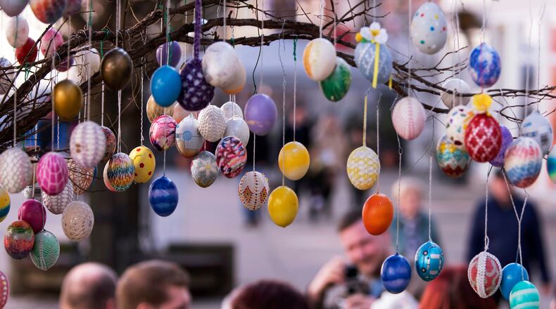 FILE - Painted Easter eggs hang from an Easter Tree in Saalfeld, central Germany, March 30, 2018. (AP Photo/Jens Meyer, File)