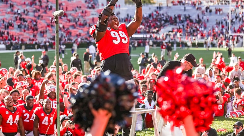 Georgia defensive lineman Jordan Davis (99) rejoices after being designated an honorary Redcoat Marching Band following the Charleston Southern game at Sanford Stadium in Athens, on Saturday, Nov. 20, 2021. (Photo by Mackenzie Miles/UGA Athletics)