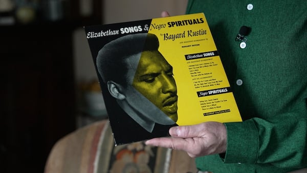 In this still image taken from video, Walter Naegle, Bayard Rustin's partner and a consultant on projects related to his life and work, holds a vinyl record in his home on Saturday, June 28, 2025, in New York. (AP Photo/Mary Conlon)