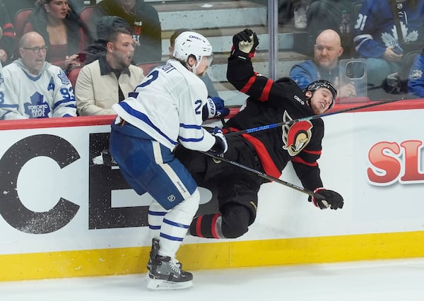 Toronto Maple Leafs' Simon Benoit (2) collides with Ottawa Senators' Dylan Cozens (24) during third period NHL playoff action in Ottawa, Saturday, April 26, 2025. (Adrian Wyld/The Canadian Press via AP)