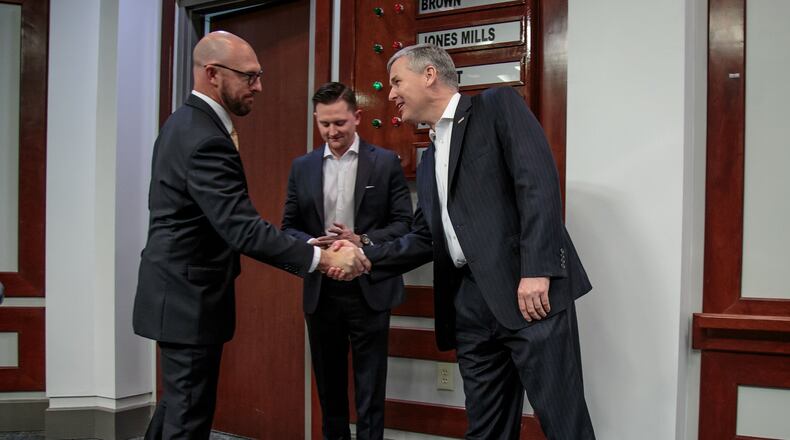GOP primary challenger Shane Hazel, left, shakes hands with U.S. Rep. Rob Woodall Thursday before their debate at the Forsyth County Administration Building in Cumming. STEVE SCHAEFER / SPECIAL TO THE AJC