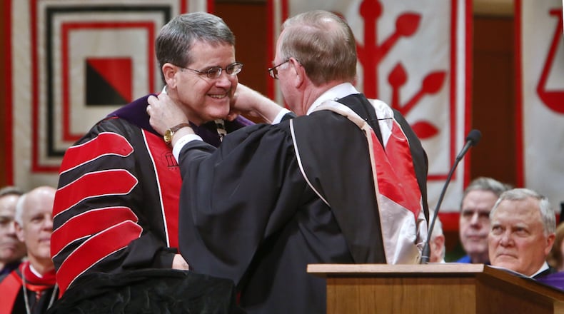 At the investiture ceremony of University of Georgia President Jere W. Morehead (left) Tuesday in Athens, the vestment, or chain of office, was placed on him by Hank Huckaby (right), chancellor of the University System of Georgia. BOB ANDRES / BANDRES@AJC.COM