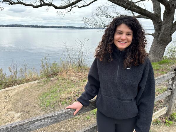 Hannah Kass, one of 61 people indicted on racketeering charges in connection with Atlanta's "Stop Cop City" movement, stands in front of Lake Mendota in Madison, Wis., on May 2, 2025. (AP Photo/Scott Bauer)
