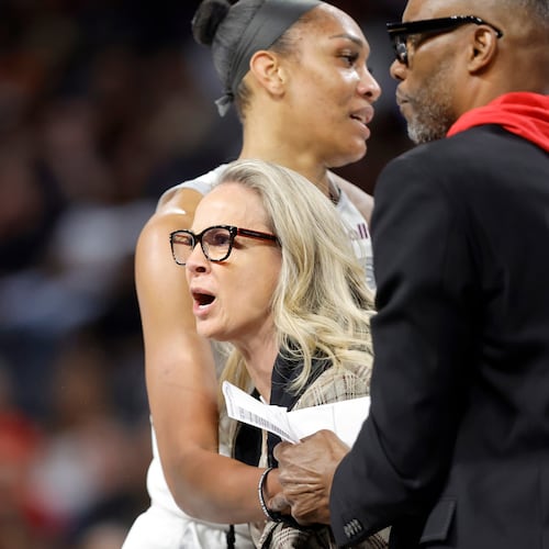 Las Vegas Aces head coach Becky Hammon is held back by Las Vegas Aces center A'ja Wilson and assistant coach Larry Lewis after being ejected during the first half of a WNBA basketball game between the Las Vegas Aces and the Atlanta Dream Tuesday, Aug. 18, 2026, in Las Vegas. (Steve Marcus/Las Vegas Sun via AP) CORRECTION: assistant coach Larry Lewis is correct instead of Tyrone Ellis