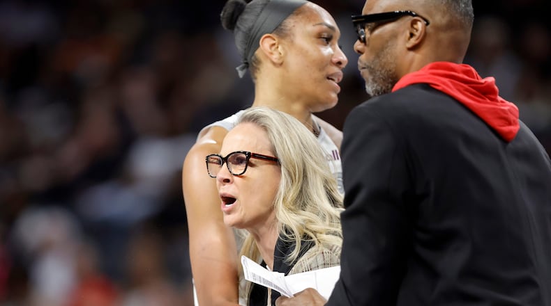 Las Vegas Aces head coach Becky Hammon is held back by Las Vegas Aces center A'ja Wilson and assistant coach Larry Lewis after being ejected during the first half of a WNBA basketball game between the Las Vegas Aces and the Atlanta Dream Tuesday, Aug. 18, 2026, in Las Vegas. (Steve Marcus/Las Vegas Sun via AP) CORRECTION: assistant coach Larry Lewis is correct instead of Tyrone Ellis