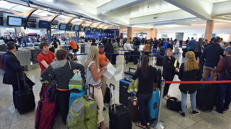 April 7, 2017 Atlanta - Delta passengers wait in line in hopes of catching their flight out of Hartsfield-Jackson Atlanta International Airport on Friday, April 7, 2017. Dozens of long lines with thousands of passengers trying to get help extended through the terminal at Hartsfield-Jackson International Airport, as the fallout of Delta Air Linesâ flight cancellations extended into a third day. HYOSUB SHIN / HSHIN@AJC.COM