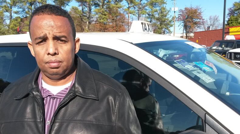 Mohamed Hussein, an Atlanta taxi driver who has an economics degree, said he spent $53,000 ona taxi “medallion” that might only be worth about $10,000 now, due to the rise of ride-share services and the city’s approach to regulation. MATT KEMPNER / AJC