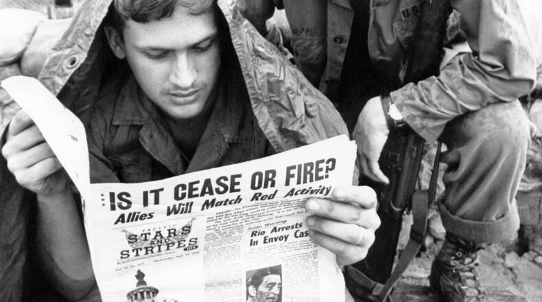 FILE - A GI with the U.S. 25th division reads Stars and Stripes newspaper at Cu Chi, South Vietnam on Sept. 10, 1969. (AP Photo/Mark Godfrey)