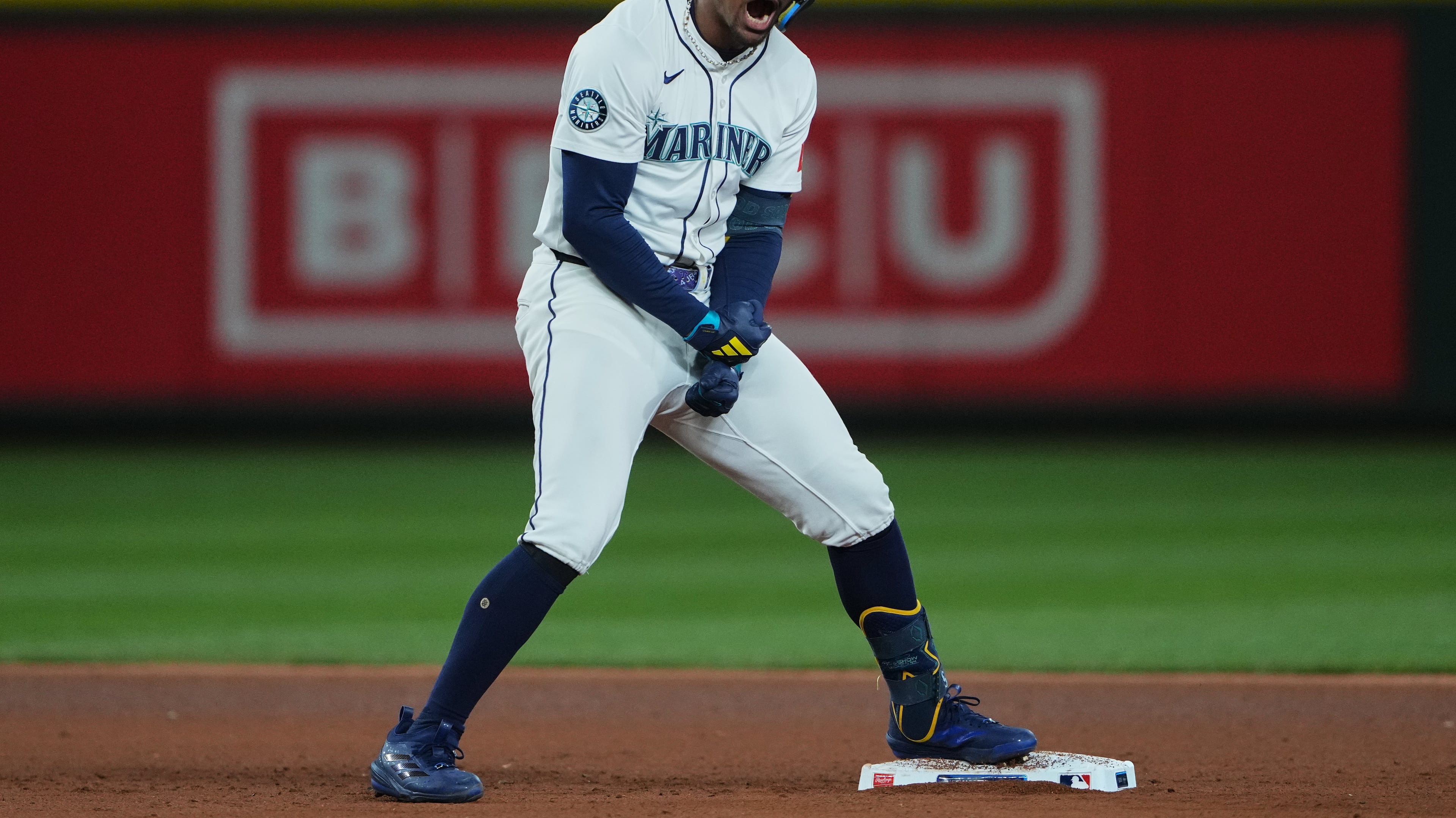 Seattle Mariners' Julio Rodriguez reacts after hitting a double to score Cal Raleigh for the go-ahead run during the eighth inning in Game 2 of baseball's American League Division Series against the Detroit Tigers, Sunday, Oct. 5, 2025, in Seattle. (AP Photo/Lindsey Wasson)