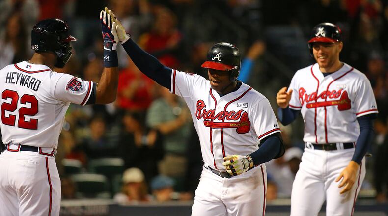 092414 Atlanta: Braves Justin Upton (center) celebrates his 2-run homer with Jason Heyward and Freddie Freeman to take a 6-0 lead over the Pirates during the fourth inning of a baseball game on Wednesday, Sept. 24, 2014, in Atlanta. CURTIS COMPTON / CCOMPTON@AJC.COM Justin Upton joins Jason Heyward as an ex-Brave. Freddie Freeman: still here. (Curtis Compton, ccompton@ajc.com)