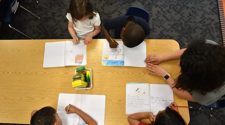 A kindergarten teacher in Marietta works with students.