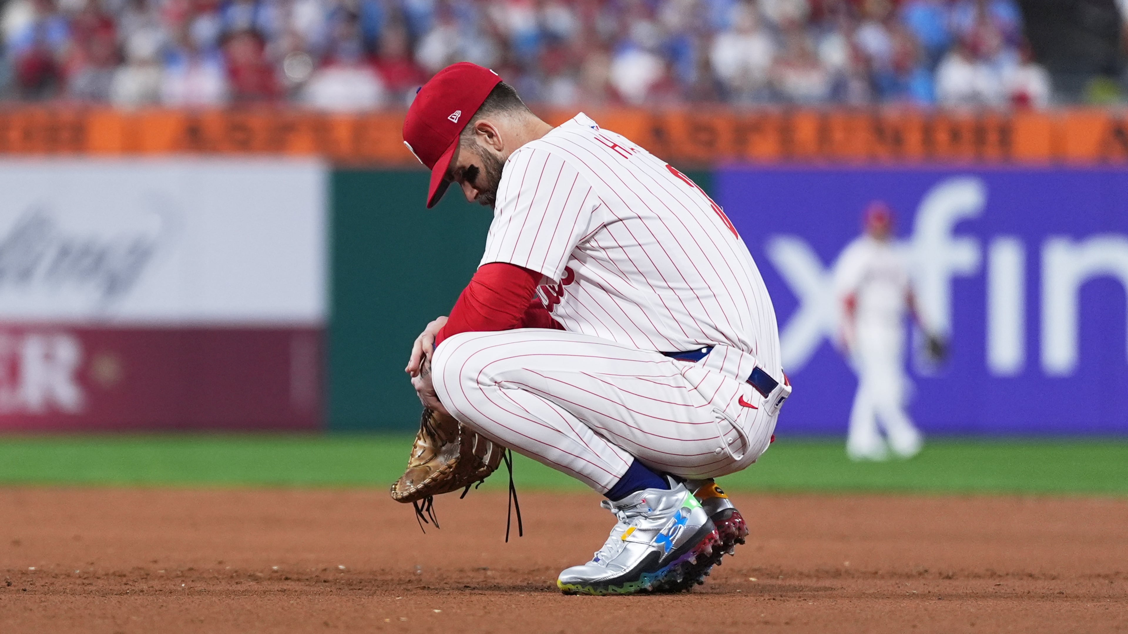 Philadelphia Phillies first baseman Bryce Harper rests during a video review during the eighth inning in Game 2 of baseball's National League Division Series against the Los Angeles Dodgers, Monday, Oct. 6, 2025, in Philadelphia. (AP Photo/Matt Slocum)