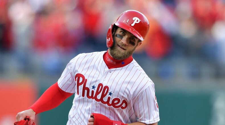 PHILADELPHIA, PA - MARCH 28: Bryce Harper #3 of the Philadelphia Phillies rounds the bases to score a run on a grand slam home run by Rhys Hoskins #17 during the game against the Atlanta Braves on Opening Day at Citizens Bank Park on March 28, 2019 in Philadelphia, Pennsylvania. (Photo by Drew Hallowell/Getty Images)