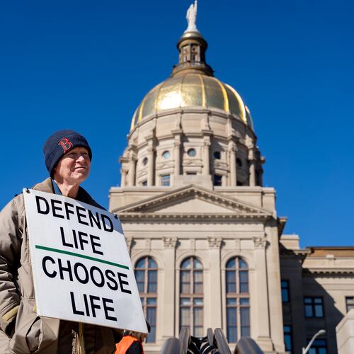 Jack Harvey holds a sign that reads “Defend life, choose life” during a silent march in the streets of downtown Atlanta to commemorate the anniversary of the 1973 Supreme Court ruling in Roe v. Wade on Friday, Jan. 24, 2025. (Ben Hendren for the AJC)