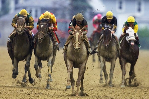 FILE- Red Bullet (4) with jockey Jerry Bailey aboard, center, breaks away from the crowd in the final stretch run of the 125th running of the Preakness Stakes at Pimlico Race Course in Baltimore, Saturday, May 20, 2000. Shown from left to right is Impeachment, with jockey Craig Perret, Fusaichi Pegasus, with jockey Kent J. Desormeaux, Red Bullet (4) , Snuck In, with jockey Cash Asmussen, and High Yield (5) with jockey Pat Day. (AP Photo/Roberto Borea, File)