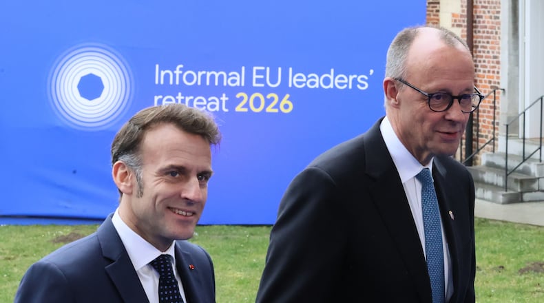 French President Emmanuel Macron, left, and Germany's Chancellor Friedrich Merz arrive for the EU summit at Alden Biesen Castle in Bilzen-Hoeselt, Belgium, Thursday, Feb. 12, 2026. (AP Photo/Francois Walschaerts)