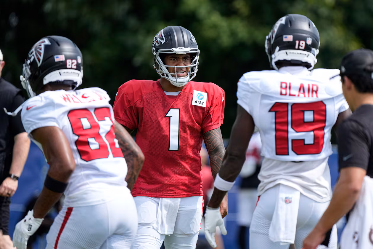 Atlanta Falcons quarterback Tua Tagovailoa (1) cuts between wide receiver Antwane Wells Jr. (82) and wide receiver Chris Blair (19) during a joint practice with the Indianapolis Colts at the team's NFL football training camp in Westfield, Ind., Wednesday, Aug. 19, 2026. (AP Photo/Michael Conroy)