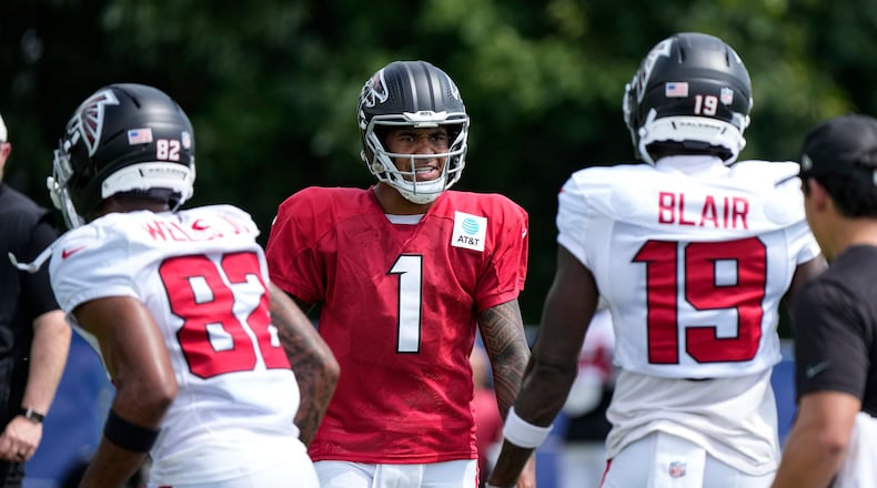 Atlanta Falcons quarterback Tua Tagovailoa (1) cuts between wide receiver Antwane Wells Jr. (82) and wide receiver Chris Blair (19) during a joint practice with the Indianapolis Colts at the team's NFL football training camp in Westfield, Ind., Wednesday, Aug. 19, 2026. (AP Photo/Michael Conroy)