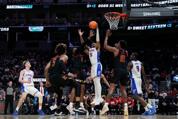 Maryland center Derik Queen (25) and Florida guard Will Richard (5) reach for a rebound during the first half in the Sweet 16 of the NCAA college basketball tournament, Thursday, March 27, 2025, in San Francisco. (AP Photo/Godofredo A. Vásquez)