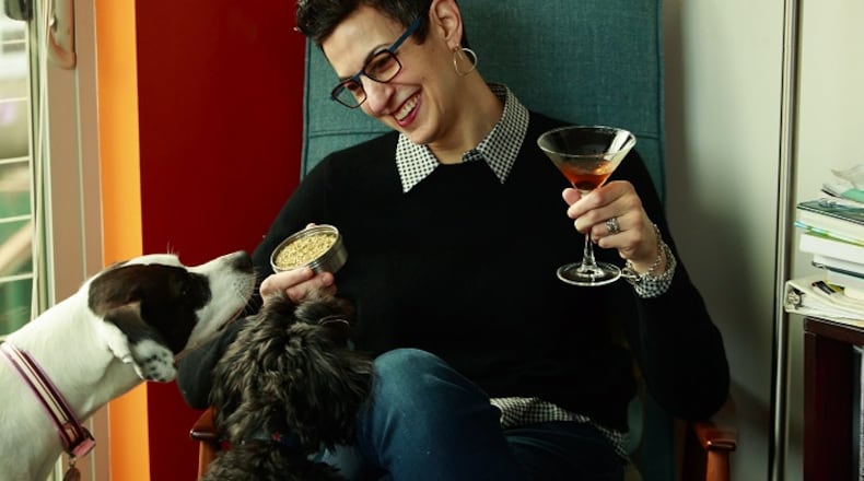 Chef and cookbook author Becky Selengut plays with her dogs, Izzy and Pippen; they're smelling dried herbs. (Erika Schultz/Seattle Times/TNS)