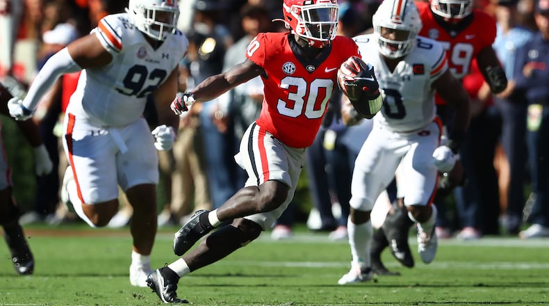 Georgia running back Daijun Edwards makes a long run for a first down against Auburn on Saturday in Athens. (Curtis Compton / Curtis Compton@ajc.com)