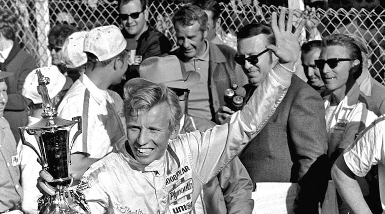 Pete Hamilton, of Charlotte, N.C., waves a trophy in Victory Lane after winning the Daytona 500 auto race at Daytona Beach, Fla. Hamilton, won four career Cup races, died Wednesday, March 22, 2017. He was 74. (AP Photo/CS, File)