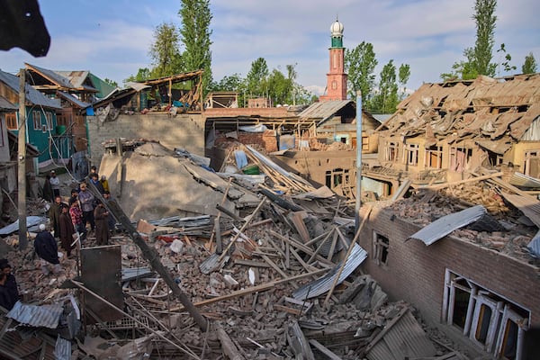 Kashmiri villagers inspect the debris of the blown-up family home of Ahsan Ul Haq Shiekh, a militant who officials say is involved in the deadly attack on tourists in Pahalgam, at Murran village in Pulwama, south of Srinagar, Indian controlled Kashmir, Saturday, April 26, 2025. (AP Photo/Dar Yasin)