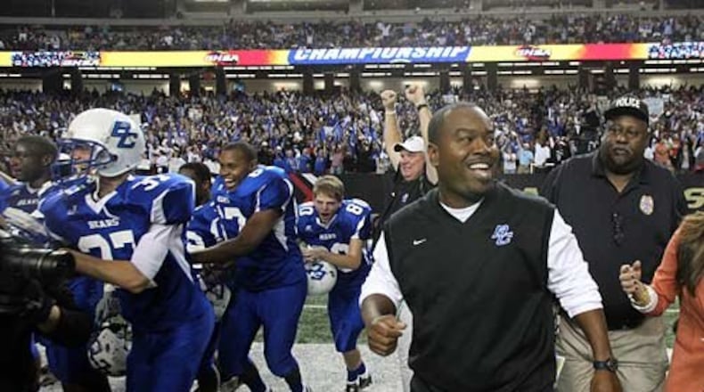 Burke County coach Eric Parker smiles as he and the rest of the Burke County football team celebrates their 28-14 win over Peach County in the Class AAA Georgia state high school football championship. Peach County lead Burke County 14-6 at the end of the first half.