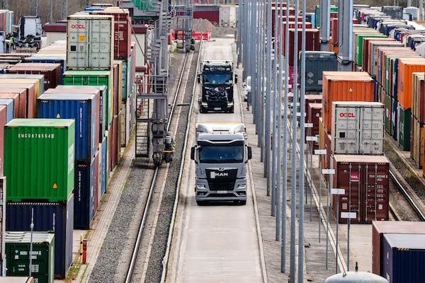 Trucks with containers drive through a logistic-terminal in Leipzig, Germany, Monday, April 7, 2025. (Jan Woitas/dpa via AP)