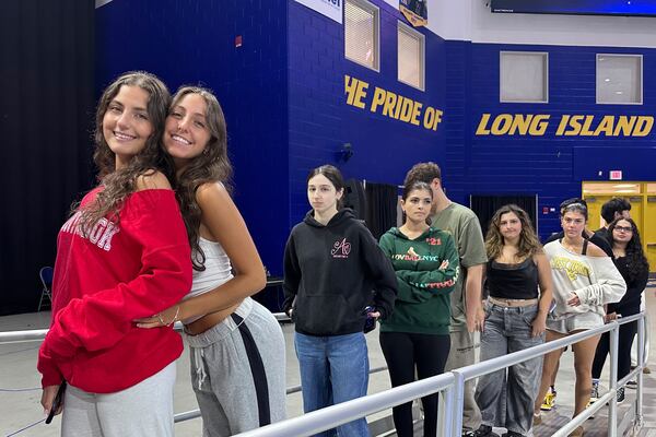 Twin sisters Arianna Cammareri, left, and Julianna Cammareri attend rehearsal for Plainview-Old Bethpage John F. Kennedy High School's graduation ceremony at Hofstra University in Hempstead, N.Y., on Tuesday, June 17, 2025. (AP Photo/Philip Marcelo)