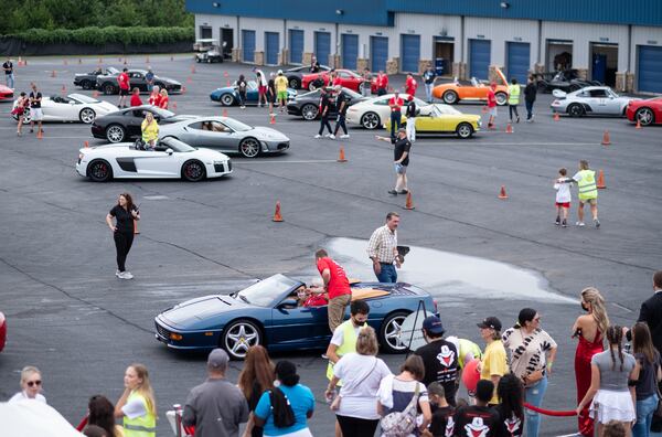 Cars line the paddock during Ferrari of Atlanta’s "Rides to Remember" event Saturday in Dawsonville. (Ben Gray for the Atlanta Journal-Constitution)
