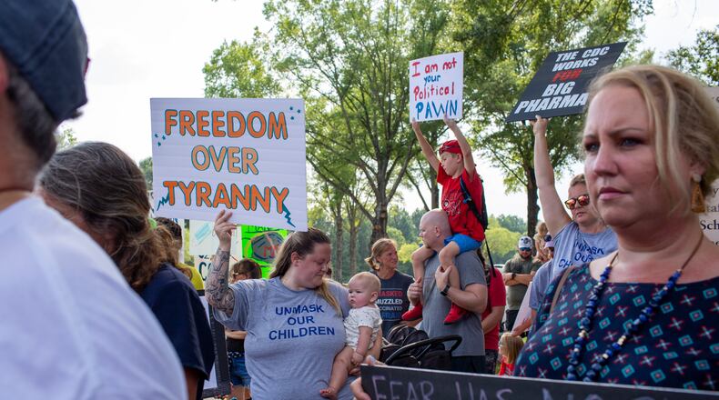People protest the Gwinnett County school system's policy mandating masks be worn in district facilities and on buses. Protests were held outside the J. Alvin Wilbanks Instructional Support Center in Suwanee, Georgia, on  July 30, 2021. (Rebecca Wright for the Atlanta Journal-Constitution)