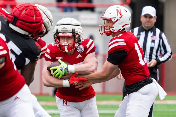 Nebraska quarterback Luke Longval (17) hands off to running back Izaac Dickey (45) during an NCAA college football practice Saturday, April 26, 2025, in Lincoln, Neb. (AP Photo/Dylan Widger)